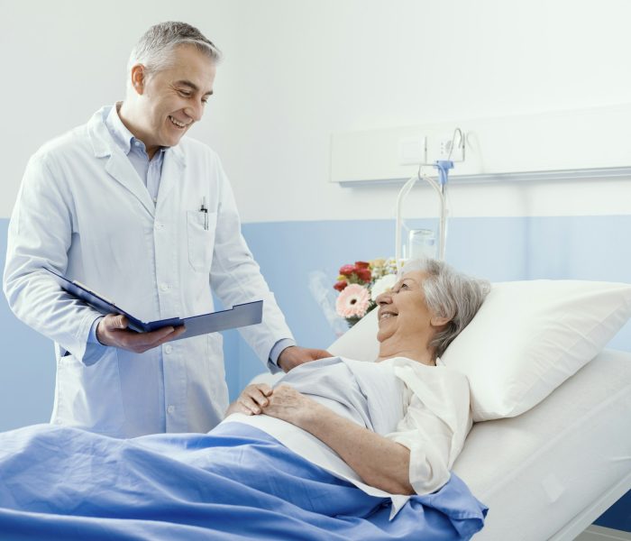 Doctor visiting an elderly patient at the hospital